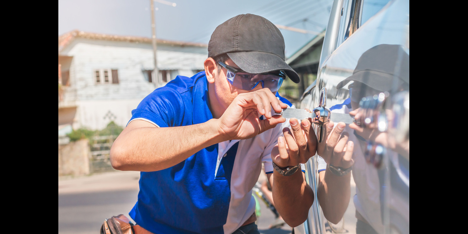 Man Unlocking a Car Lock in an emergency lockout situation