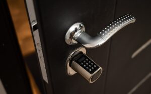 A close-up view of a modern door handle with an integrated electronic keypad lock.
